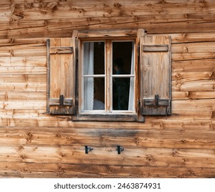 Wooden window with shutter on rental mountain hut - Powered by Shutterstock