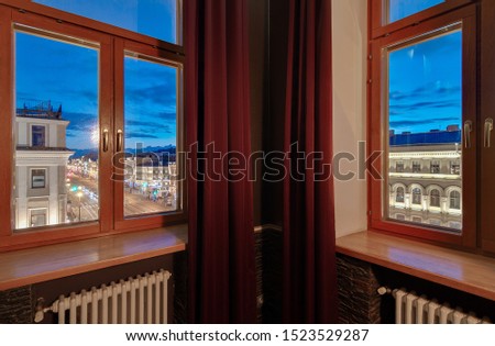Wooden windows overlooking night Nevsky Prospect in Saint Petersburg. Interior of the apartment
