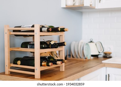 Wooden wine supply with bottles on table in modern kitchen. - Shutterstock ID 1934032859