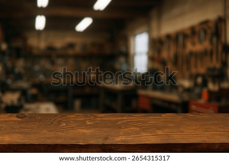 Wooden Workbench Table in Workshop Background. Empty Wood Surface for Product Display, Carpentry, DIY, Hand Tools, Garage, Industrial, Blurred Background, Rustic, Craftsmanship. For display or montage