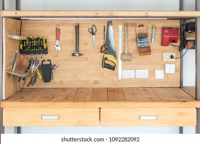 Wooden workbench at workshop. Lot of different tools for diy and repair works. Wood desk for product display. Copyspace. Labour day
