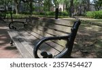 Wooden and wrought iron bench in savannah park : chippewa square. Isolated seat in an urban park with nobody. On a spring day. Georgia. 