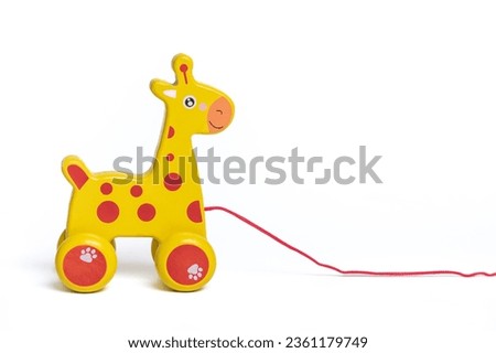 Wooden yellow horse on wheels isolated on white background Educational children's toys