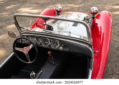 WOODLAND, CA, U.S.A. - JULY 24, 2021: An Overhead Closeup Of The Interior Of A Classic Red Lotus  Roadster Convertible.car With Chrome Hood And Gearshift And Steering Wheel.