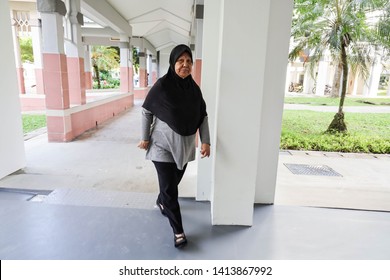 Woodlands / Singapore - June 2nd 2019: A Malay Lady Is Taking A Walk At The Void Deck Area.