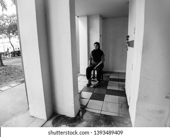 Woodlands / Singapore - May 10th 2019: A Cleaner Is Taking A Rest At The Void Deck.