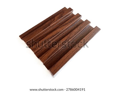 Wood-patterned PVC fluted wall panel sample, isolated on white background. Linear interior decorative cladding material for modern home renovation, architecture design, and DIY wall decor.