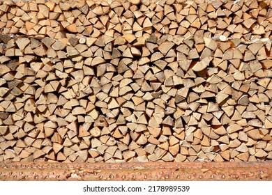 A woodpile of wood chopped for burning in the oven.Preparation for winter. A bunch of logs. Background with firewood.Buying and selling firewood for winter