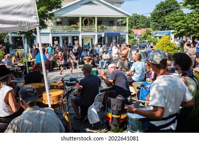 Woodstock, NY, USA - Aug 8, 2021: A man and woman dance to the sounds of a community drum circle held at the Village Green during the summer afternoon. 