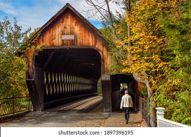 WOODSTOCK, VERMONT, USA - OCTOBER 10, 2015: Covered bridge surrounded by fall color in the countryside of Vermont, USA