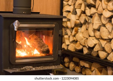 Woodstove Fire With Wood Pile