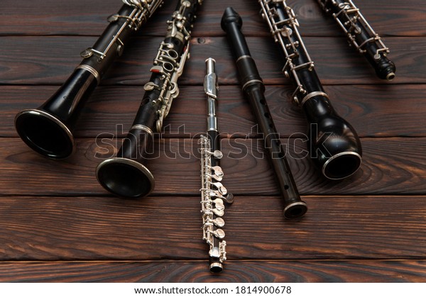 Woodwind instruments lie on a wooden surface. View\
from above