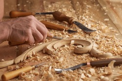 Woodwork And Wood Carving. Carpenter's Hands Use Chiesel. Senior Wood Carving Professional During Work. Man Working With Woodcarving Instruments