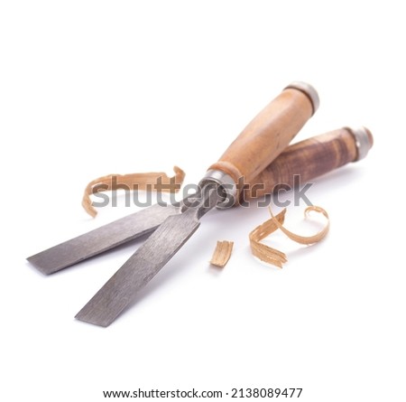 Woodworking carpenter chisel tool closeup and wood shavings isolated on white background. Chisel as joiner tool