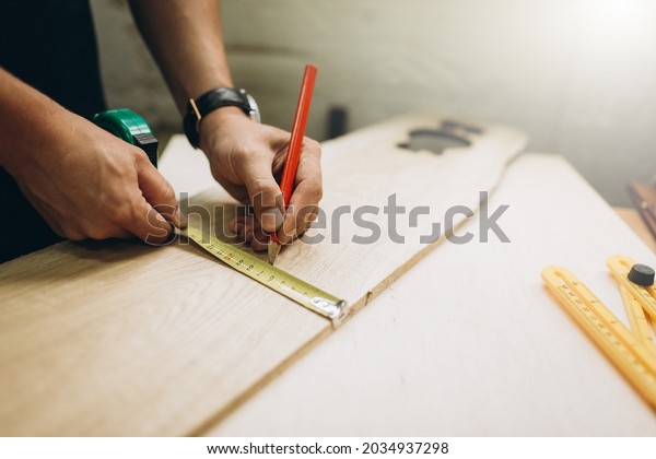 Woodworking carpenter furniture hand cuting.Man\
factory industry manufacturer, working workshop, maker\
construction. Skills artisan workshop\
factory