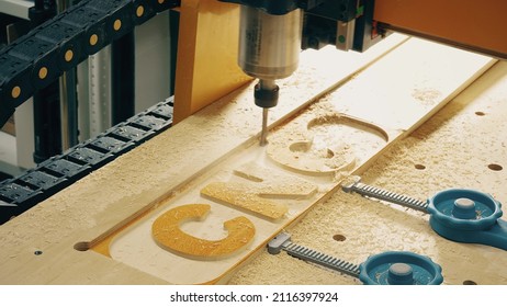 Woodworking CNC Machine Bit Cuts Out Wooden Letters, Close-up Shot