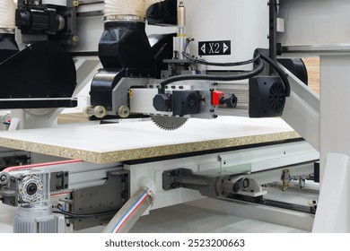 Woodworking factory with big machine for cutting chipboard wood boards, machines and machinery for the production of furniture and wooden products - Powered by Shutterstock