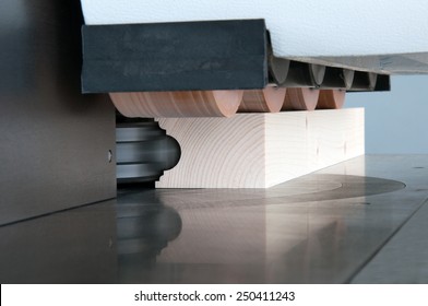 Woodworking - In wood shape a profile on molder machine