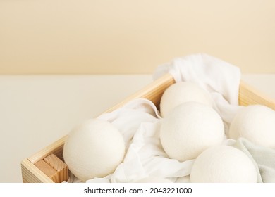 Wool Dryer Balls On Textile Cloth In Wooden Box. Eco Friendly Laundry Supplies. Alternative Drying Of Linen. Flat Lay. 