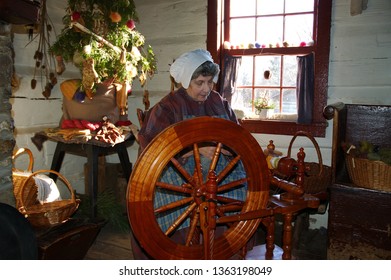 Wool Spinner In Log Cabin At Black Creek Pioneer Village Toronto, Ontario, Canada - December 5, 2004