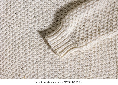 Wool Sweater Sleeve For Winter On Beige Texture Background