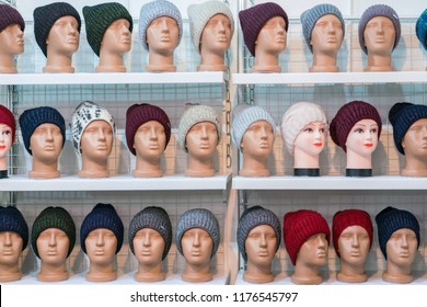 Woolen hats on the silvery heads of the mannequins in the store. a variety of female winter knitted hats on mannequin heads - Powered by Shutterstock