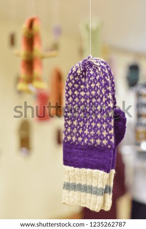 woolen knitted mittens on a full color background