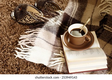 Woolen Plaid, Coffee Cup, Book And Slippers On Shaggy Carpet. Top View.