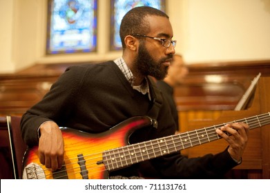 WORCESTER, MASSACHUSETTS - MARCH 6, 2011: Archdiocese Of Boston Black Catholic Choir Member Kyle Miles Performs On Guitar At St. Peter's Catholic Church In Worcester.