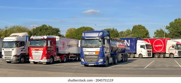 Worcestershire, England - September 2021: Articulated lorries parked in a row at the M5 motorway service station at Strensham.