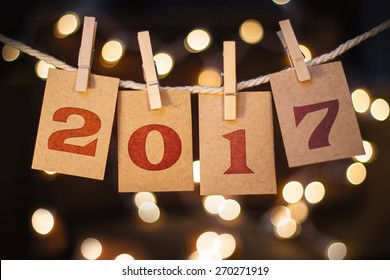 The word 2017 spelled out on clothespin clipped cards in front of glowing lights. - Shutterstock ID 270271919