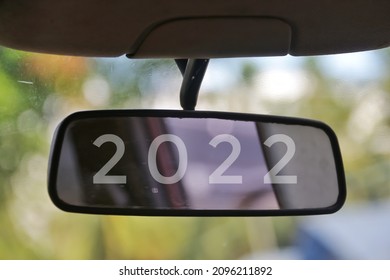 the word 2022 on the rear view mirror of the car. merry christmas and new year 2022