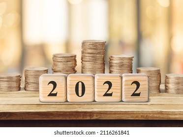 Word 2022 put on cubes with coins stack on desk. Savings New year Concept. - Shutterstock ID 2116261841