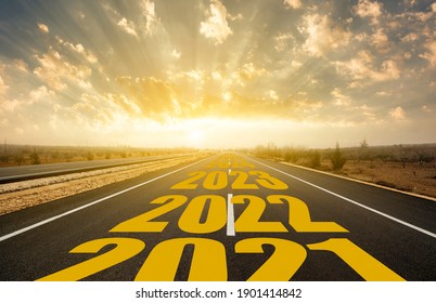 The Word 2022 Written On Highway Road In The Middle Of Empty Asphalt Road At Golden Sunrise