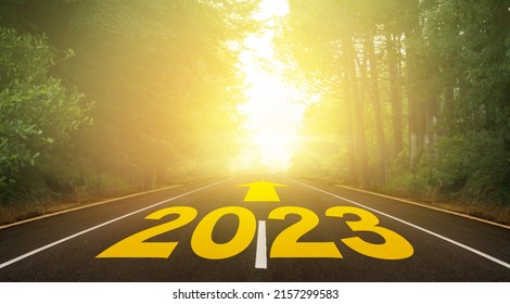 The Word 2023 Written On Forest Road. Concept For New Year 2023. The Route To The New Year Indicated By The Arrow. Anniversary Planning For Hope And Future Concept