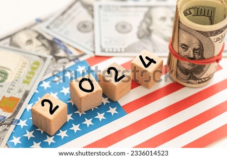 Word 2024 written by wooden cubes with american flag and american dollar bills.