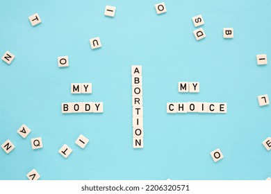 The Word Abortion On A Blue Background. Reproductive Rights.Flat Lay