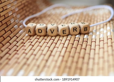 Word adverb lined with wooden cubes - Shutterstock ID 1891914907