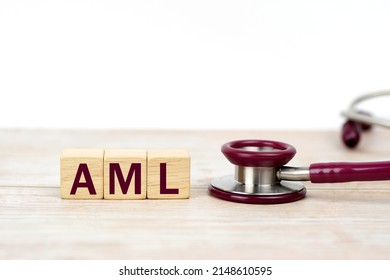 Word AML (Acute Myeloid Leukemia) On Wooden Blocks And Stethoscope On White Background. Leukemia Treatment, Clinic And Medical Busines.clinic And Medical Busines.                             