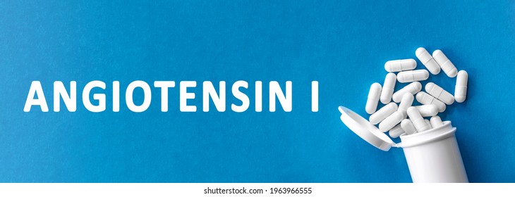 The word ANGIOTENSIN II is written near pills on a light blue background. Medical, health and happiness concept. inactive form of protein angiotensin, precursor to active form angiotensin II - Shutterstock ID 1963966555
