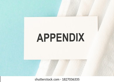 Word Appendix With Medical Mask On A Blue Background.