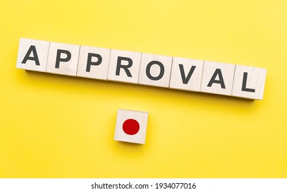 The Word Approval Written On Wood Blocks With Button. Concept Of Approving In Business Or Finance.