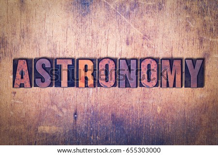 The word Astronomy concept and theme written in vintage wooden letterpress type on a grunge background.