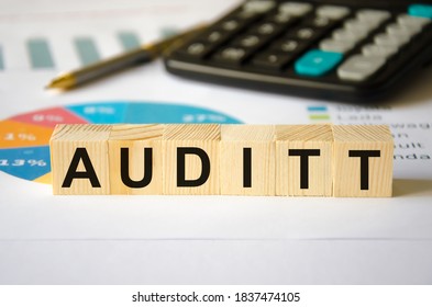  the word audit is written on the wood cubes that lie on the financial charts. High quality photo - Shutterstock ID 1837474105