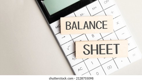 Word BALANCE SHEET On Notebook With Calculator,pencil And Glasses On White Background.Business Concept.