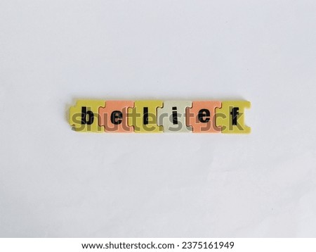 Word belief made of colourful blocks  on a white background.