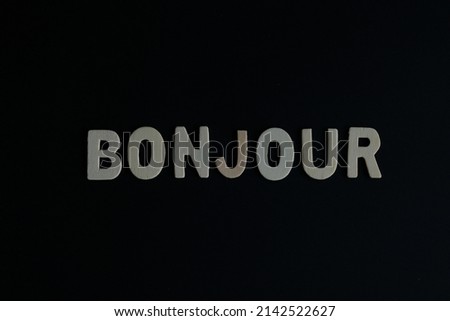 Word 'Bonjour' on black background. Bonjour is the word for French say Hello or greetings.