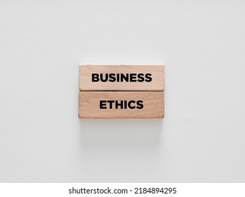 The Word Business Ethics On Wooden Blocks On White Background. Business Integrity And Good Governance Concept. 