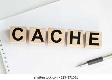Word CACHE written on wooden cubes on a light background