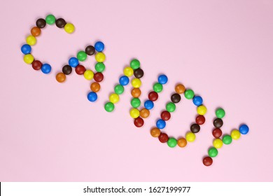 The word "candy" are contained by colored candies on a pink background - Powered by Shutterstock